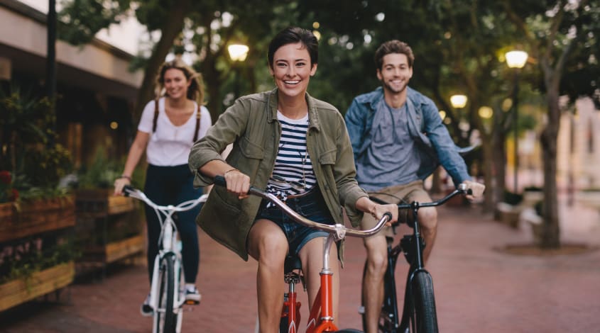 three friends riding bicycles
