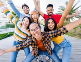 a diverse group of young adults smiling outside